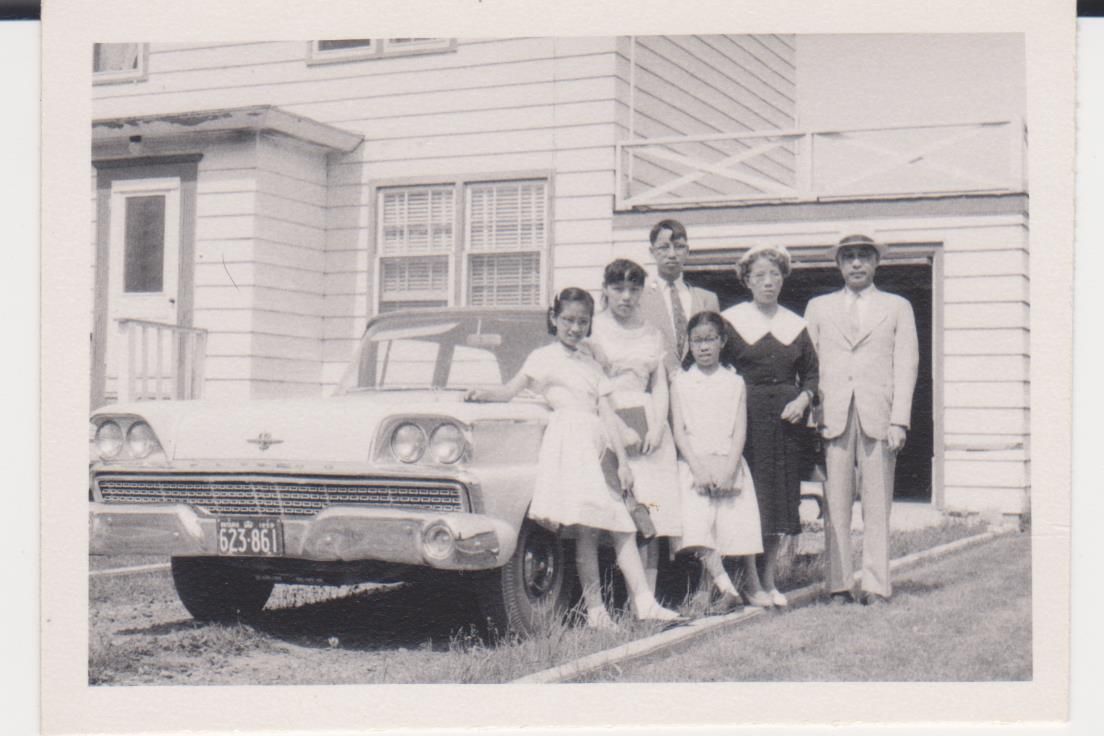 Members of the Chiang family posing in front of their new Ford automobile before church, summer of 1959. (L-R:) daughters Ella and Cora, son David, daughter Ming, wife Sarah, Dr. Thomas Chiang.